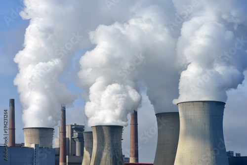 Germany, North Rhine Westphalia, Neurath, Cooling towers releasing clouds of water vapor photo