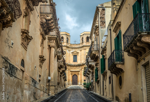 Street in historic part of Noto city, Sicily in Italy, view with Montevergine Church