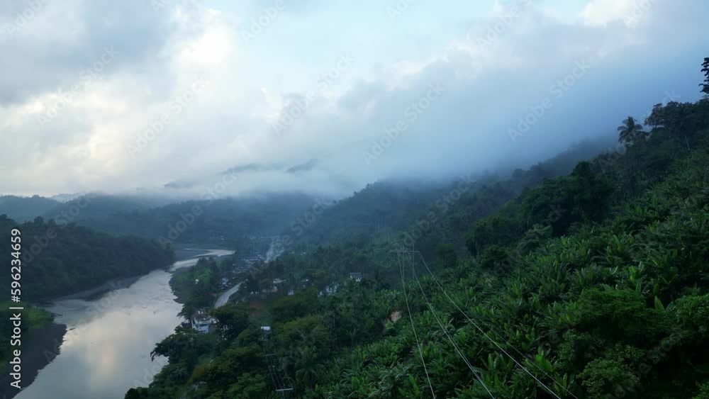 Flying Towards Dense Trees On The Mountains With River During Sunrise In Catanduanes, Philippines. Aerial Drone Shot Flying Towards Dense Trees On The Mountains With River During Sunrise In Catanduanes, Philippines. Aerial Drone Shot