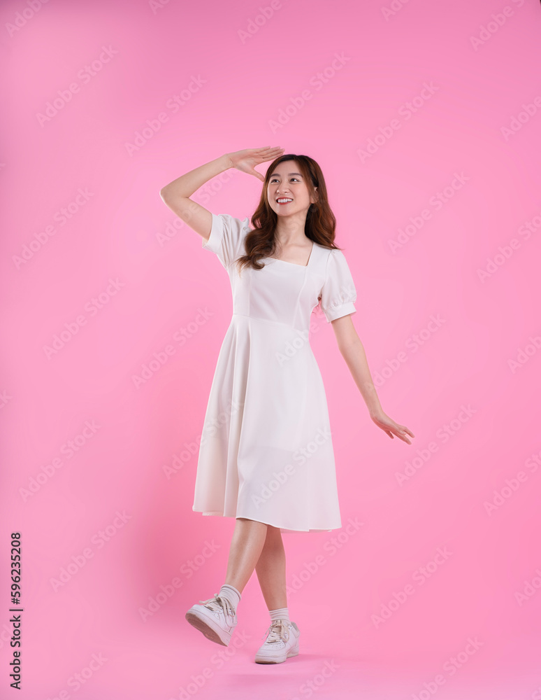 full body image of asian woman in skirt posing on pink background full body image of asian woman in skirt posing on pink background