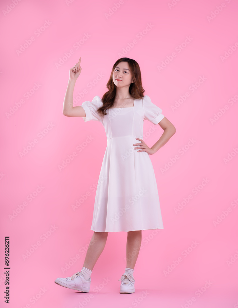 full body image of asian woman in skirt posing on pink background full body image of asian woman in skirt posing on pink background