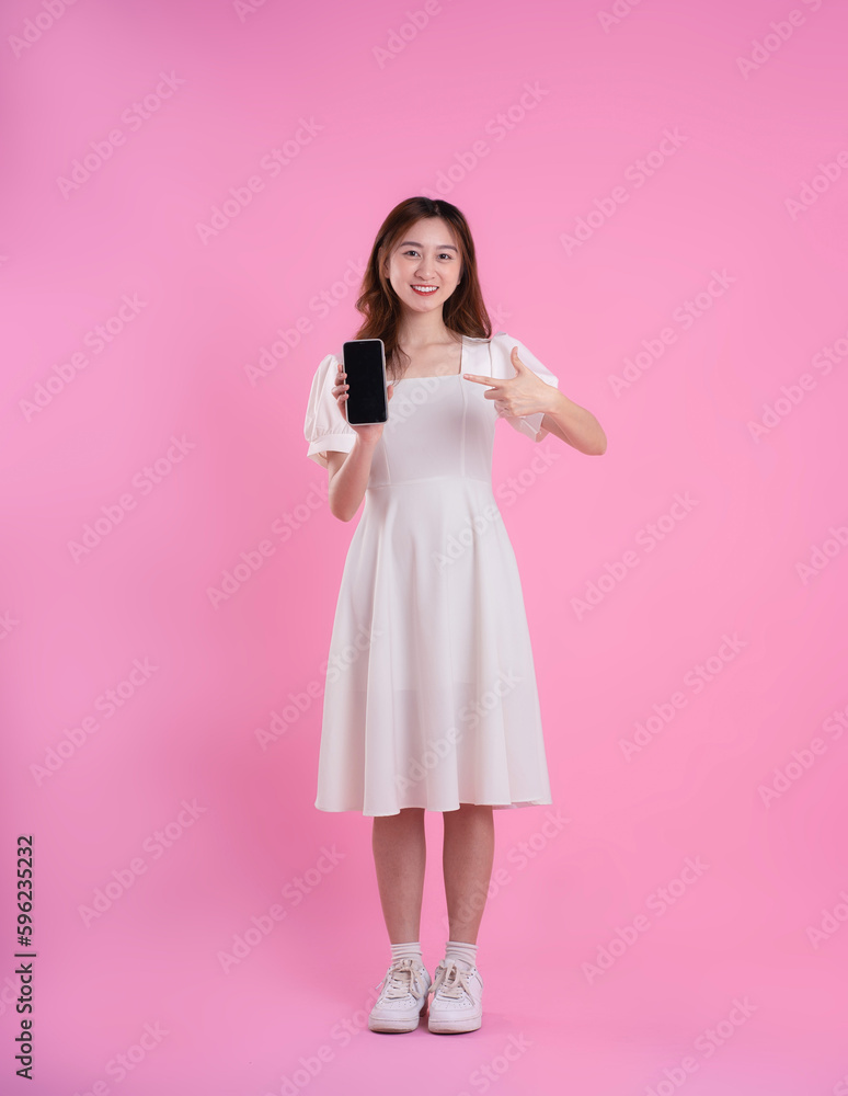 full body image of asian businesswoman using laptop on pink background full body image of asian businesswoman using laptop on pink background