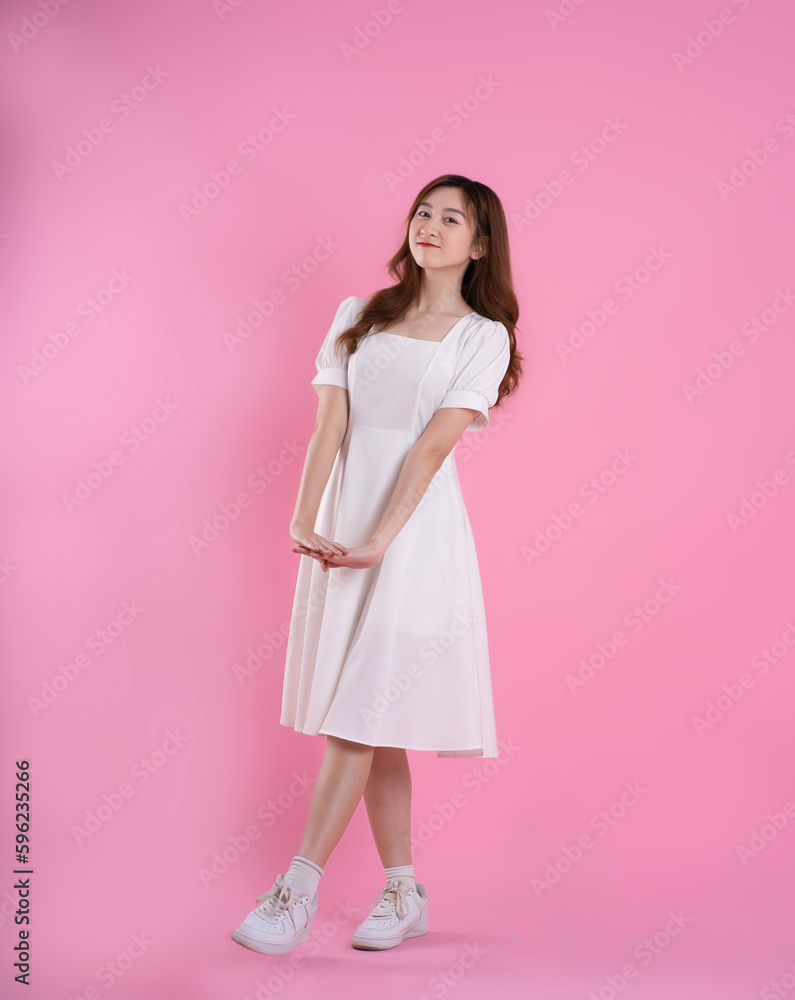 full body image of asian businesswoman using laptop on pink background full body image of asian businesswoman using laptop on pink background
