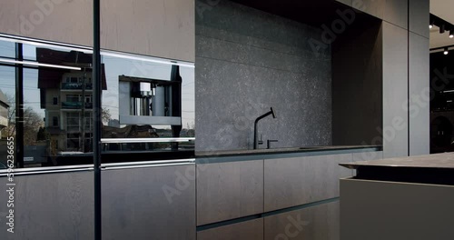 Modern and spacious wooden kitchen room. Real Estate. Modern Chrome Faucet. Minimalist design in New Home. Real Luxury Design Interior. Neoclassic Style, cozy interior.