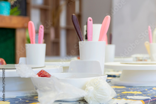 On table are devices and ingredients for preparation of festive cake. Master class in cooking for children.