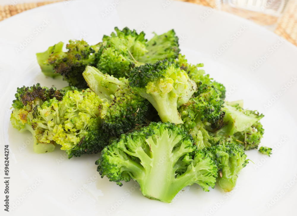 fried inflorescences of broccoli with provencal herbs on white plate fried inflorescences of broccoli with provencal herbs on white plate
