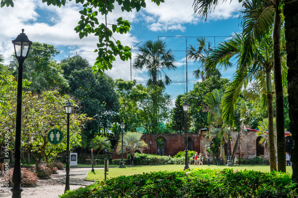 The lush gardens at Fort Santiago,with palm trees and retro street lamps,Intramuros,Manila,The Philippines.