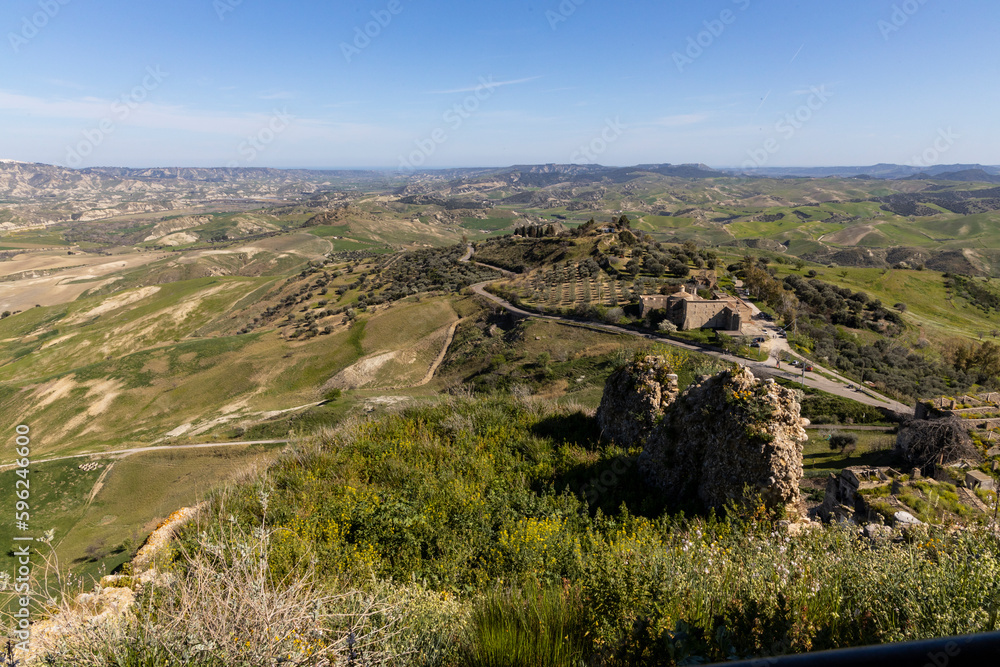 Naklejka premium Craco, Basilicata. Abandoned city. A ghost town built on a hill and abandoned due to geological problems. Surreal look, horror film scenery. Panorama of the Calanchi Park.