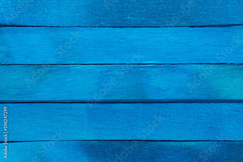Old blue wooden background. Wooden textured background. Wooden painted blue boards are located horizontal in a row.