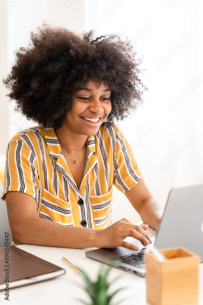 Smiling black woman with laptop at home Smiling black woman with laptop at home