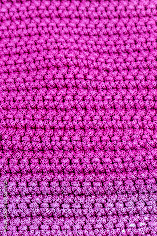 Pink knitted fabric as a background. Close-up. Texture Pink knitted fabric as a background. Close-up. Texture