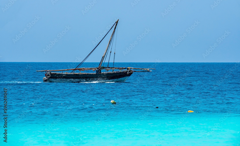 Obraz premium fishing boat on the beach of zanzibar, Tansania