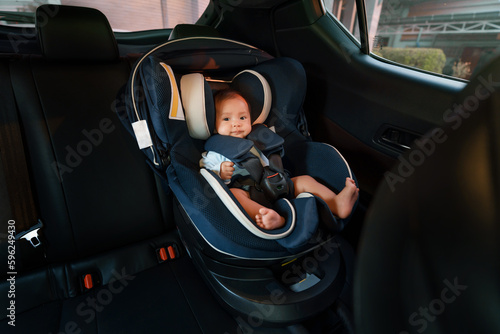 Tableau sur toile happy newborn baby sitting in infant car seat, safety chair travelling
