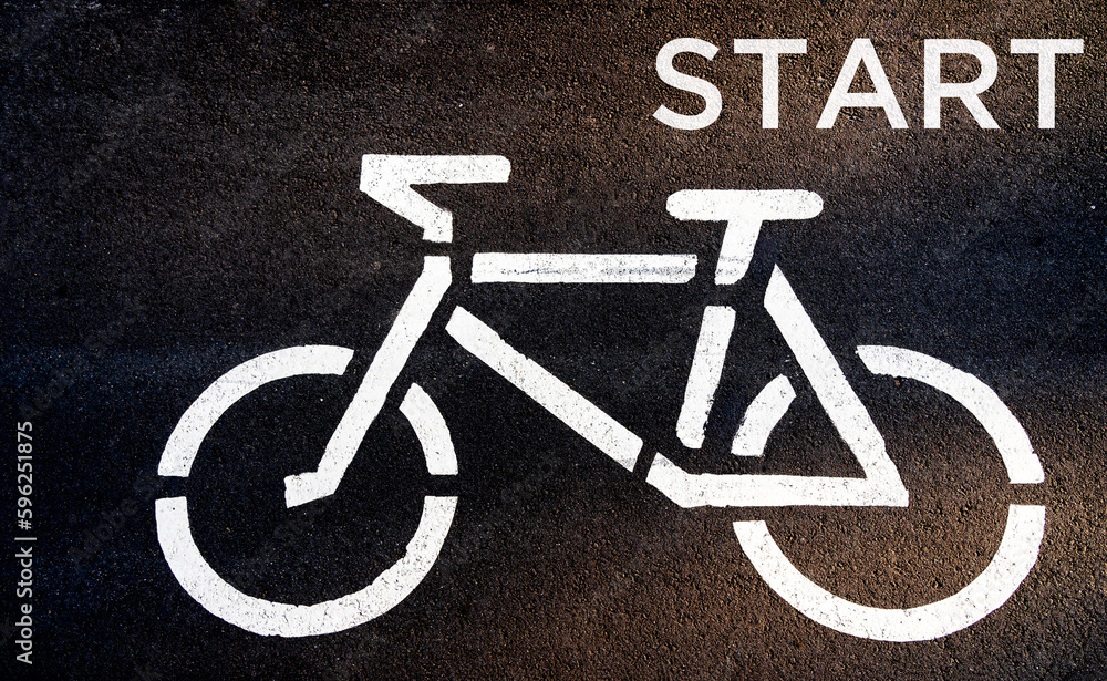 Active sporty people concept image. Symbol to indicate the road for bicycles. White bicycle road sign. Cycling, start. Traffic way symbol or sign on a bicycle. Active sporty people concept image. Symbol to indicate the road for bicycles. White bicycle road sign. Cycling, start. Traffic way symbol or sign on a bicycle.