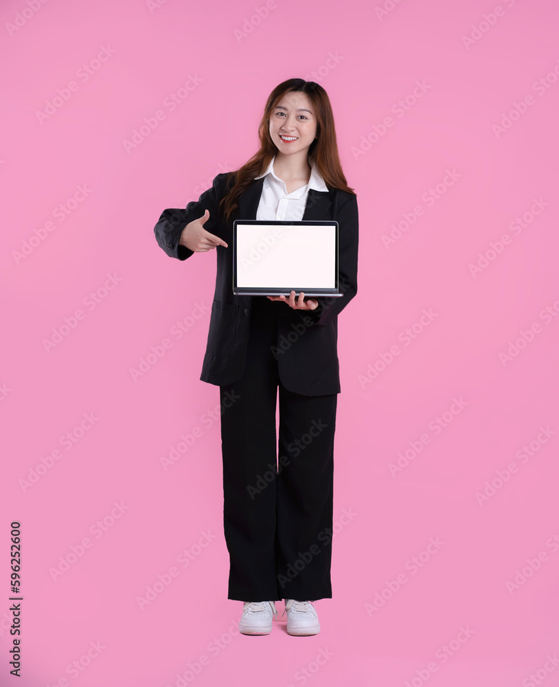 full body image of asian businesswoman using laptop on pink background full body image of asian businesswoman using laptop on pink background