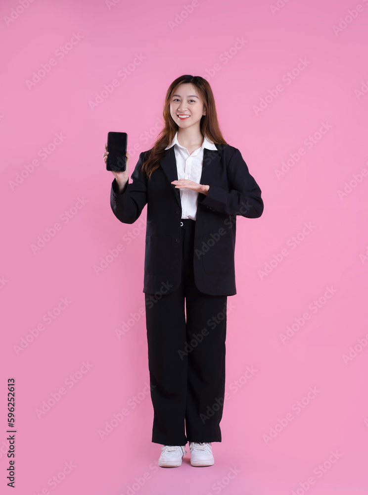 full body image of asian businesswoman using phone on pink background full body image of asian businesswoman using phone on pink background