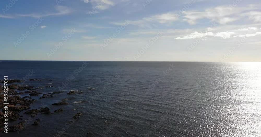 Looking Out To Horizon On Sunny Day Across The English Channel With Aerial Pan Left To Reveal Thurlestone Coastline In South Devon. Looking Out To Horizon On Sunny Day Across The English Channel With Aerial Pan Left To Reveal Thurlestone Coastline In South Devon.