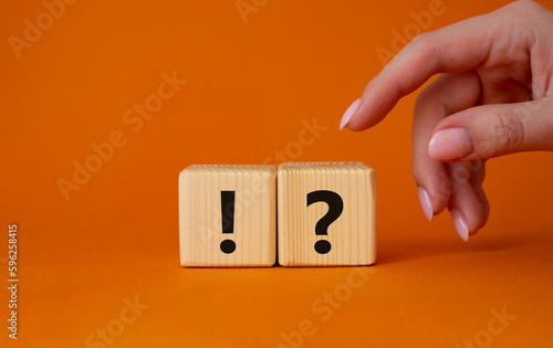 Wallpaper Mural Question mark and exclamation mark symbol. Question mark and exclamation mark on wooden cubes. Businessman hand. Beautiful orange background. Business concept. Copy space. Torontodigital.ca
