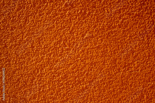 Abstract orange background. Plastered textured wall.