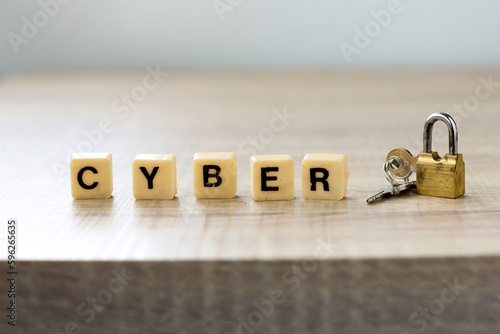 Cyber lettering with padlock on wooden table