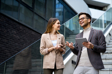 Successful business colleagues people working together on digital devices.