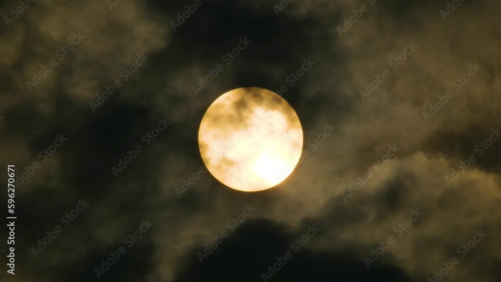 Close up, Yellow Full Moon behind fast moving dark clouds. Close up, Yellow Full Moon behind fast moving dark clouds.