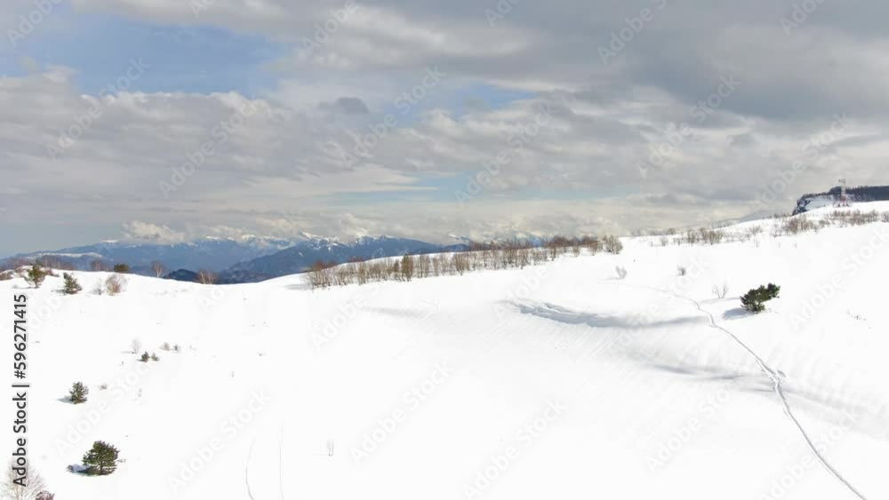 Beautiful Winter Mountain Landscape on a Cloudy Day Aerial Shot. Ski Resort Top View. Beautiful Winter Mountain Landscape on a Cloudy Day Aerial Shot. Ski Resort Top View.
