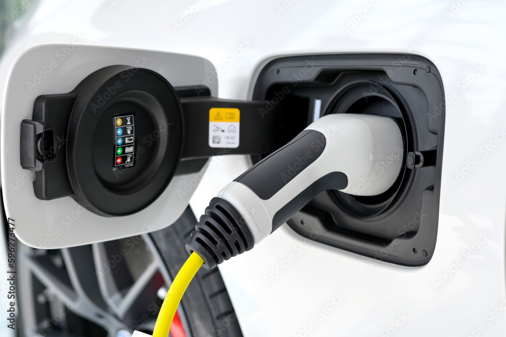 Power cable pump plug in charging power to electric vehicle EV car. Power cable pump plug in charging power to electric vehicle EV car.