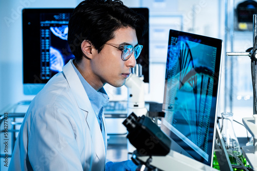 Portrait of a young Asian man conducting a scientific experiment in a laboratory.