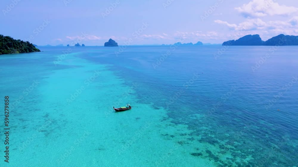 Longtail boats at a turqouse colored ocean in Koh Kradan Island Thailand Longtail boats at a turqouse colored ocean in Koh Kradan Island Thailand