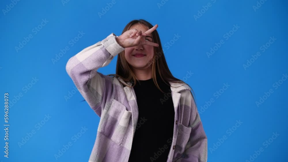 4k video of one girl posing for a video over blue background. 4k video of one girl posing for a video over blue background.