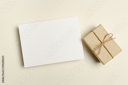 Blank greeting card mockup with gift box in paper background, empty mockup with copy space