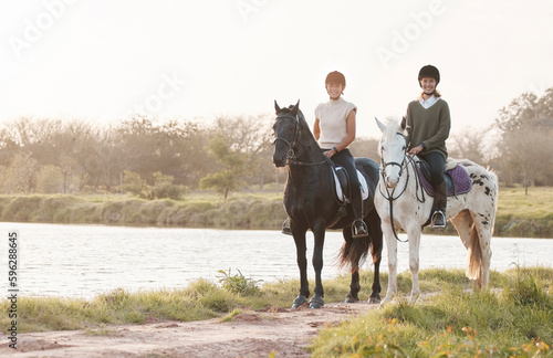 Exploring on horseback is as relaxing as it gets. Shot of two young women out horseback riding together.