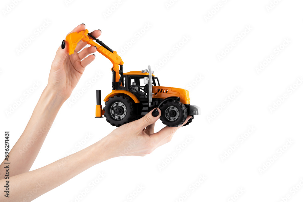 Tractor in female hands. Excavator. Grader. Children's toy. Tractor Isolated on white background