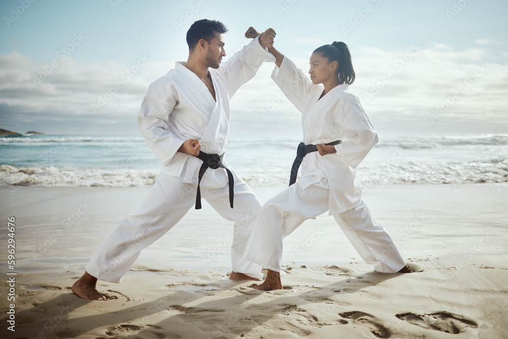 Its important to know self defense. Full length shot of two young martial artists practicing karate on the beach. Its important to know self defense. Full length shot of two young martial artists practicing karate on the beach.