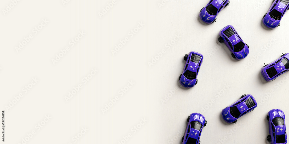 Children's toy cars arranged on a white table, top view, cars in blue, space for text Children's toy cars arranged on a white table, top view, cars in blue, space for text