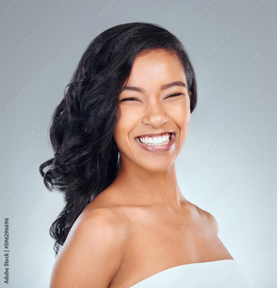 Shes absolutely gorgeous. Studio portrait of an attractive young woman posing against a grey background. Shes absolutely gorgeous. Studio portrait of an attractive young woman posing against a grey background.
