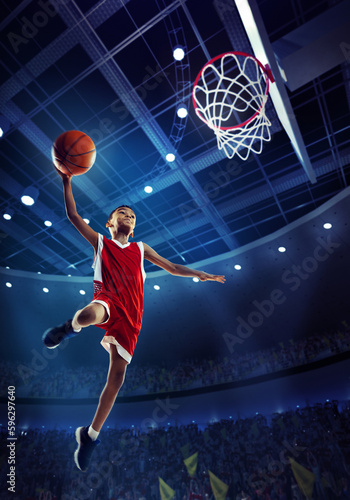 Dynamic image of little boy, child, basketball player in motion, jumping with ball during match on 3D stadium with flashlights. Championship. Concept of professional sport, competition, action, motion