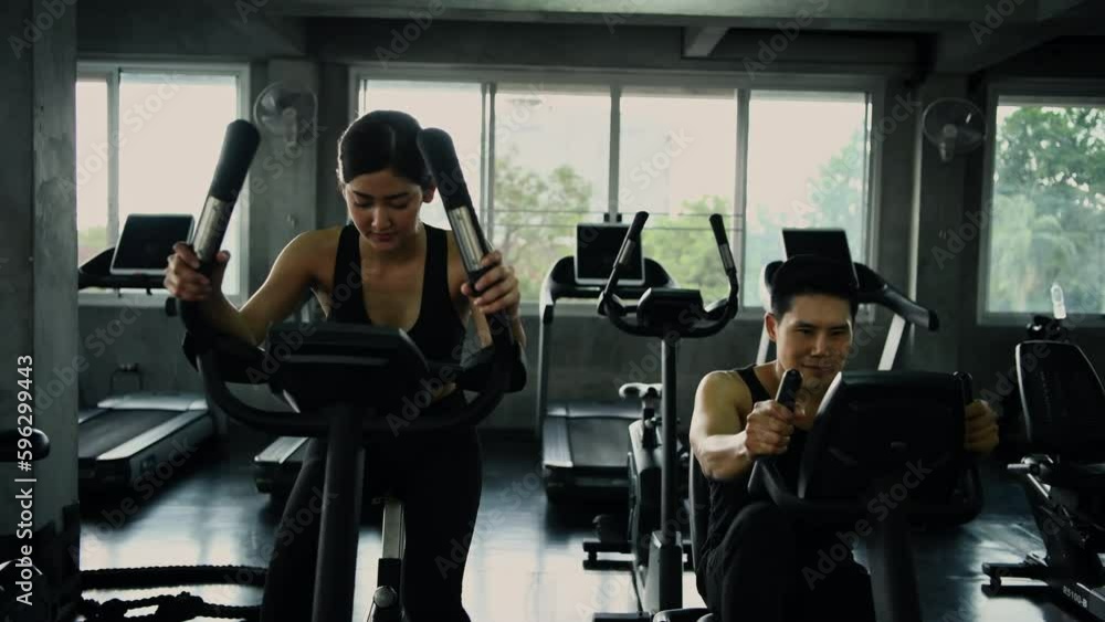 Fitness concept of 4k Resolution. Athletes are cycling together in the fitness center. Fitness concept of 4k Resolution. Athletes are cycling together in the fitness center.