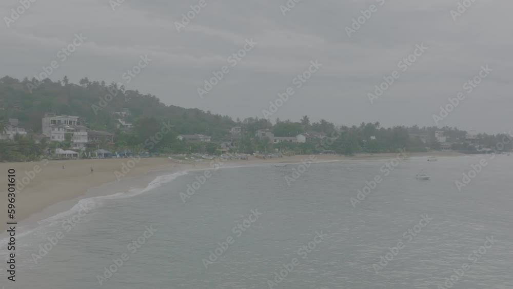 A beautiful sandy beach on a tropical island. An Asian village by the ocean. Water on the sand, a soothing picture of a vacation. Slow motion 120 fps, ProRes 422, 10 bit, ungraded C-LOG A beautiful sandy beach on a tropical island. An Asian village by the ocean. Water on the sand, a soothing picture of a vacation. Slow motion 120 fps, ProRes 422, 10 bit, ungraded C-LOG