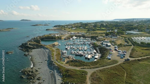 Flight over Beaucette Marina flying south, north east coast of Guernsey on bright sunny day showing marina built in an old quarry and views over Herm, Jethou and Sark and further out to sea photo