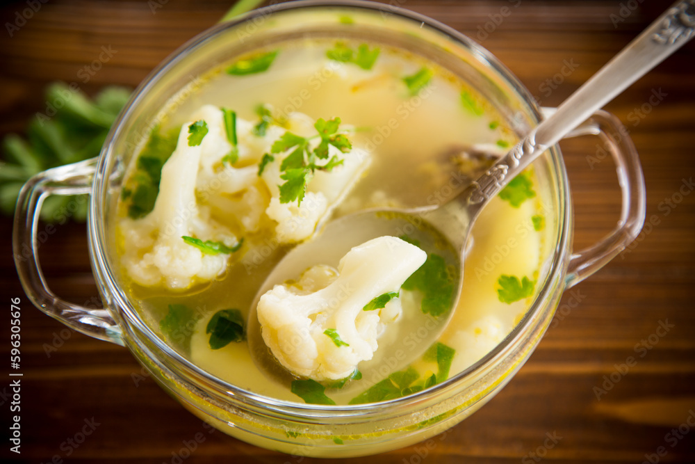 cooked chicken soup with cauliflower and vegetables in a bowl cooked chicken soup with cauliflower and vegetables in a bowl
