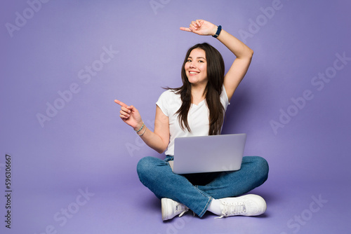 Happy woman promoting a copy space ad using a laptop