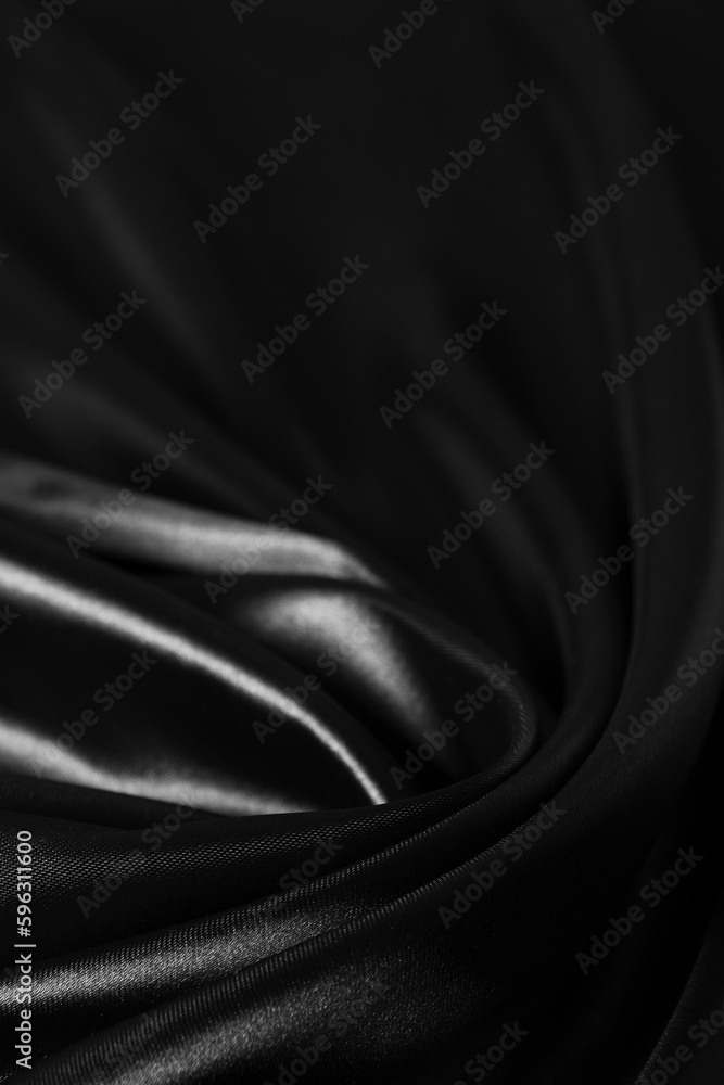 Obraz premium Background black twisted silk fabric,abstract texture satin fabric.
