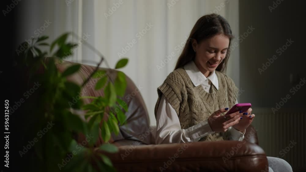 Portrait of happy teen girl messaging online in smartphone application smiling looking away. Satisfied confident beautiful Caucasian teen indoors Portrait of happy teen girl messaging online in smartphone application smiling looking away. Satisfied confident beautiful Caucasian teen indoors