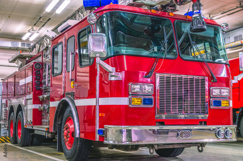 A red car with chrome body parts designed to deliver firefighters to the place of fire and to extinguish fires. Fire truck with retractable ladder for extinguishing fires at height. 