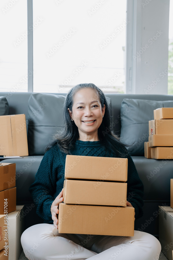 woman holding parcels and looking to camera, standing among several boxes in modern office. woman holding parcels and looking to camera, standing among several boxes in modern office.