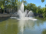Nîmes, France - 04 19 2023: The Gardens of La Fontaine. View of water jets from the fountain quay.
