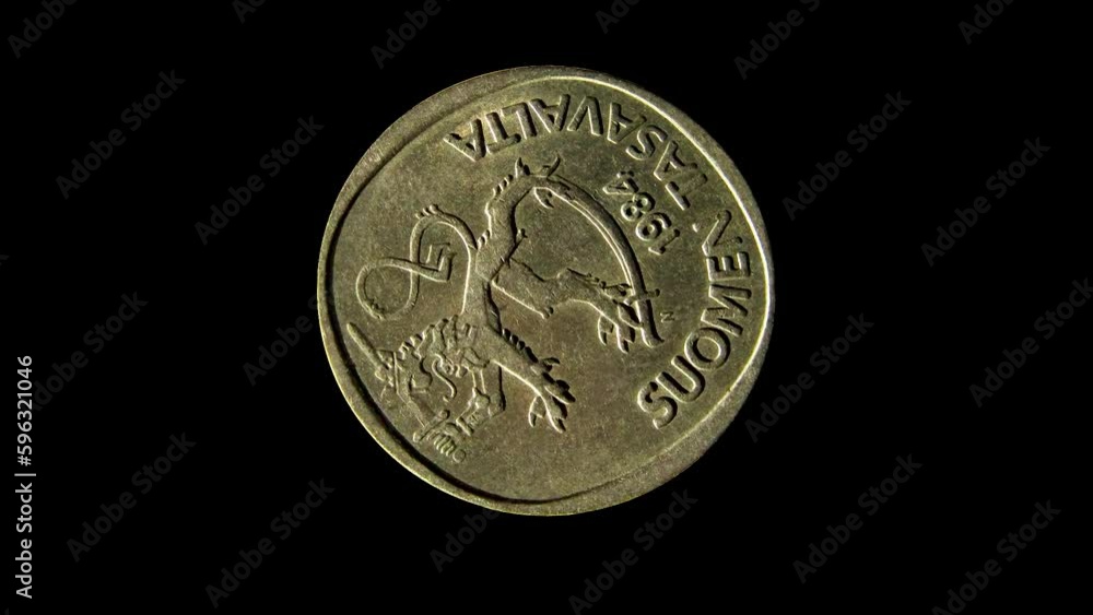 Obverse of Finland old coin 1 markka 1984 isolated in black background. 4k video Obverse of Finland old coin 1 markka 1984 isolated in black background. 4k video