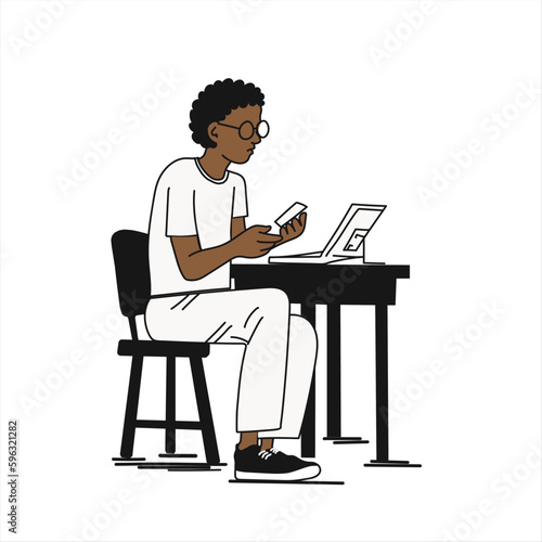 Young afro boy working on his laptop.